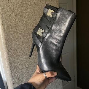 Black pleather heals with gold straps and some suede.